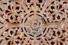 Close up image of a Lina carved wooden wall panel made from solid mango wood, featuring detailed hand-carved floral patterns—an elegant wooden wall decoration with artisanal charm.