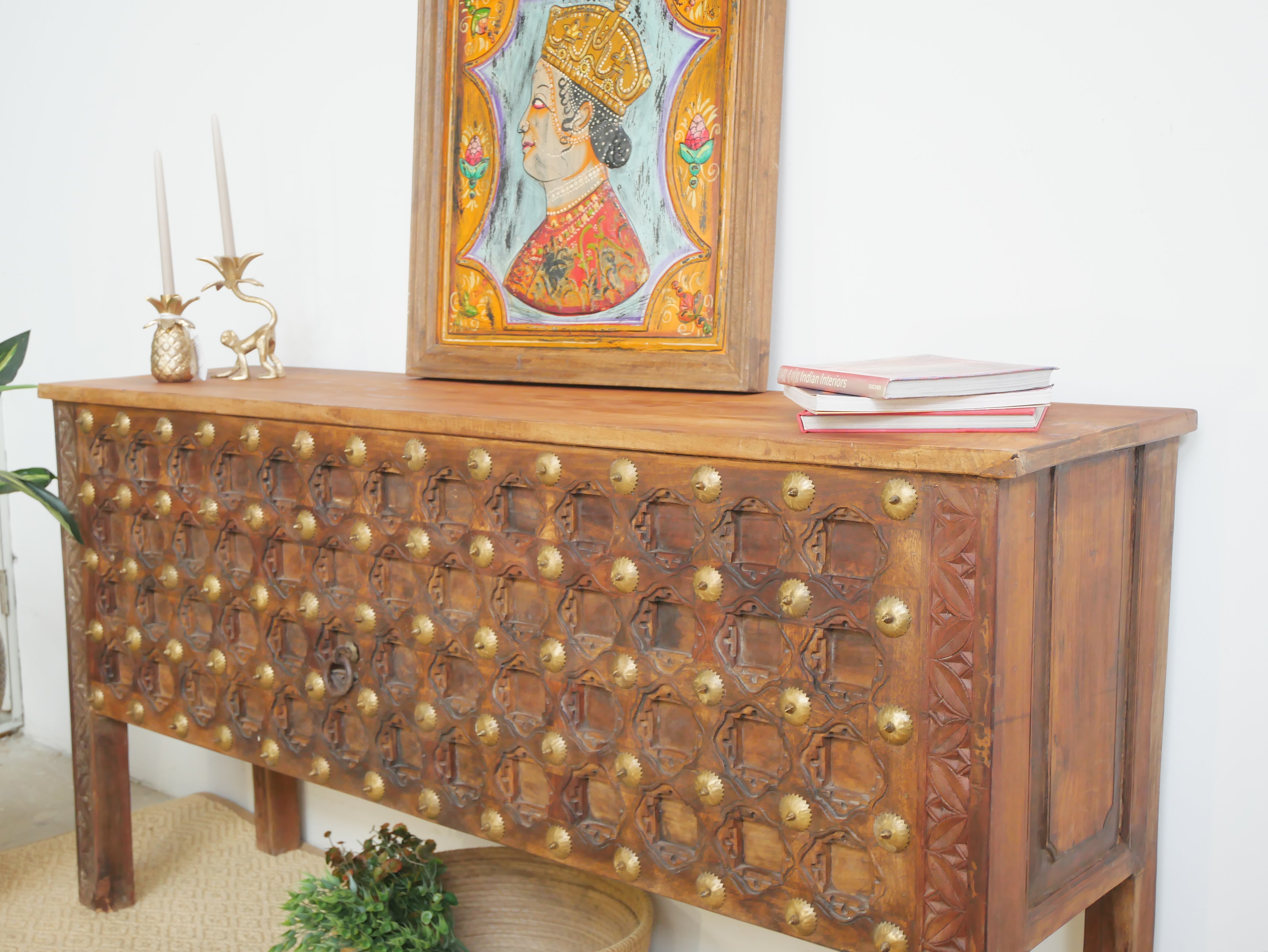 Side angle image of a reclaimed teak wood console table with antique door front and brass fittings; sustainable furniture, 170 × 90 × 48 cm.