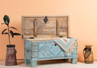 Side angle image with open lid of a blue hand-carved mango wood chest with floral and geometric carvings – wood chest box perfect for boho style storage or decorative accent.