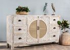 Side angle image of a white mango wood and rattan sideboard with six drawers and two compartments—handcrafted bedroom furniture blending Indian artistry with Scandinavian design.