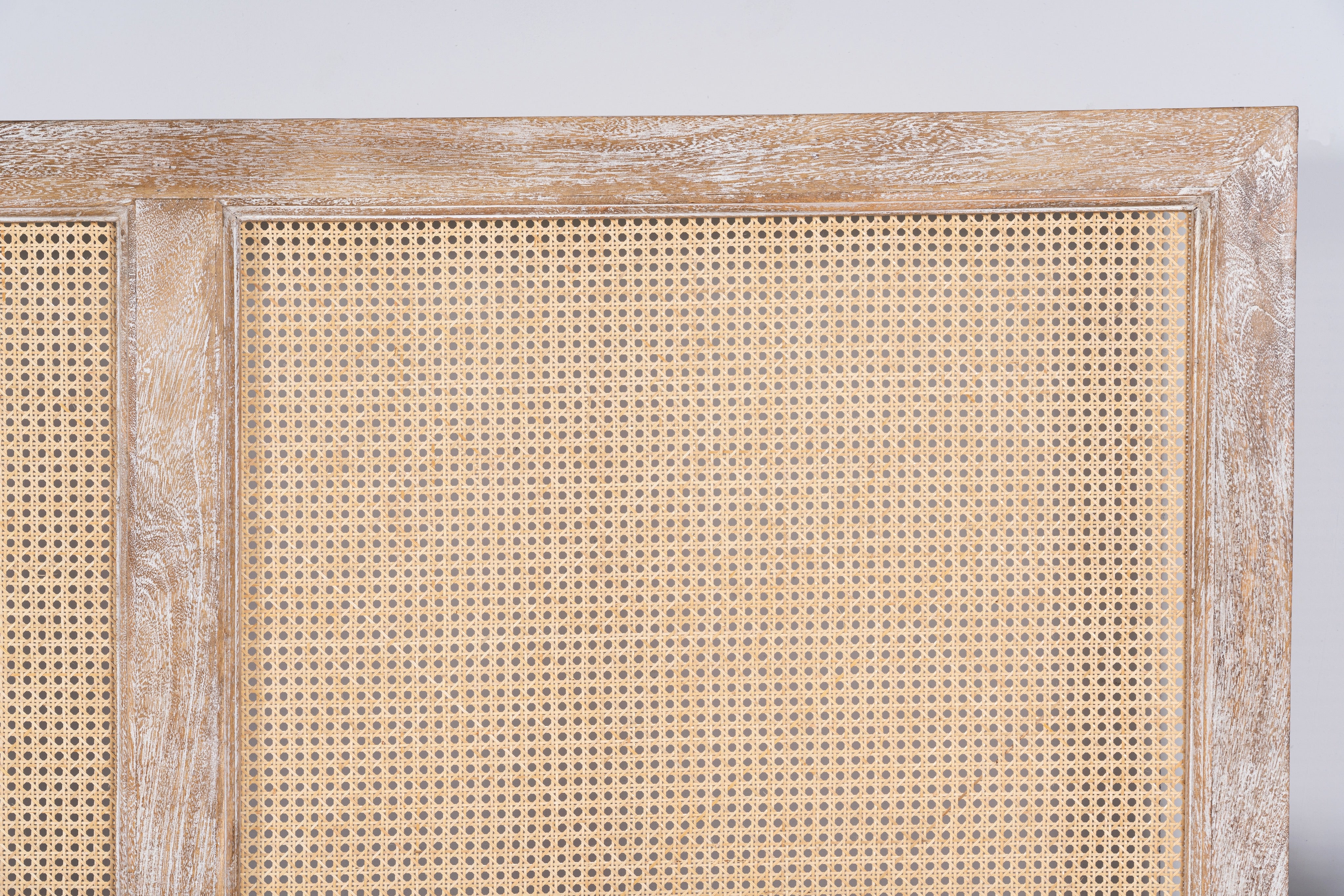 Image of the head board of a handcrafted Indian bed Tapti in solid mango wood with rattan panels, artisanal bedroom furniture, 180 × 200 cm.